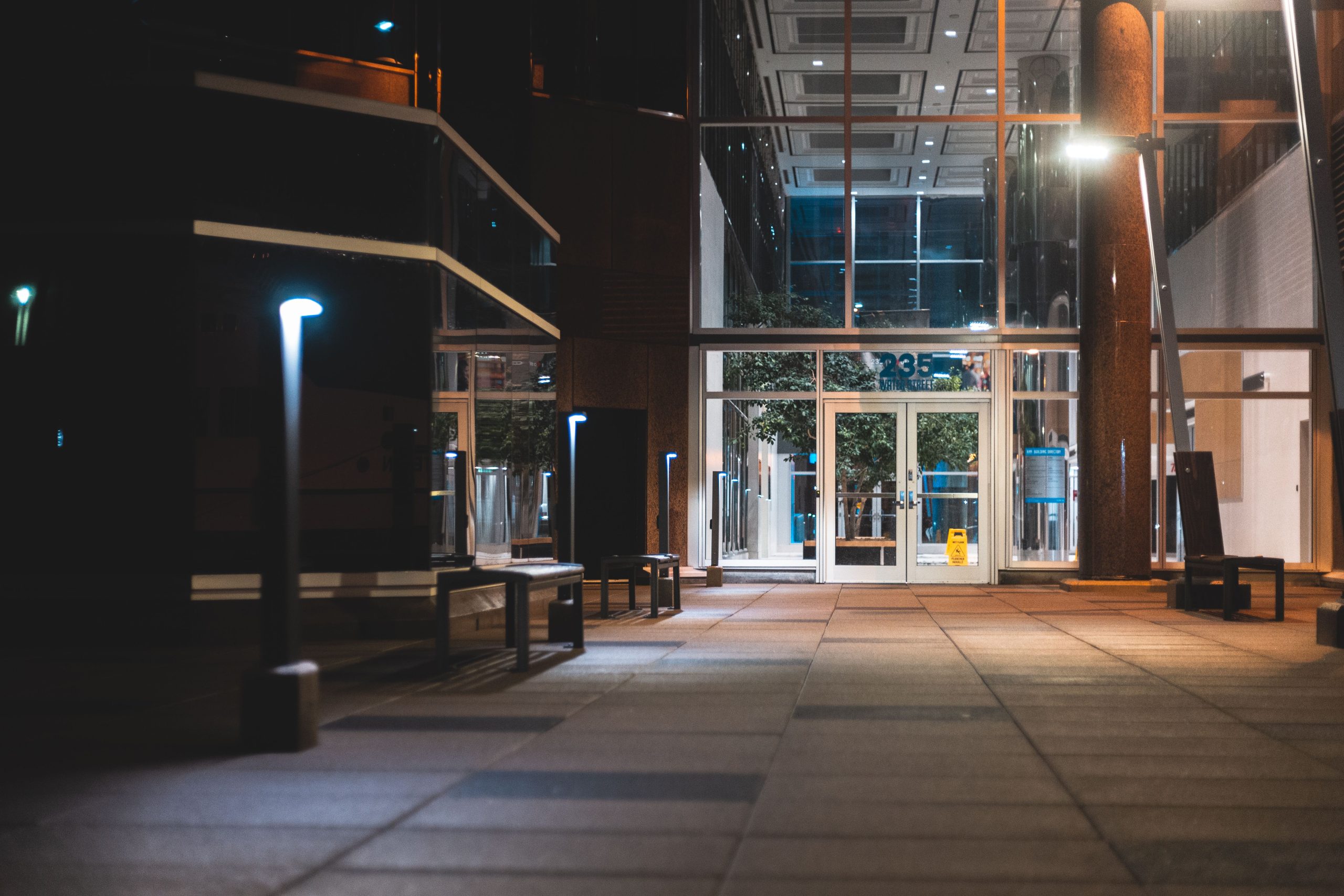 Modern glass office entrance at dusk representing Tradeproofs independent supply chain verification contact desk.