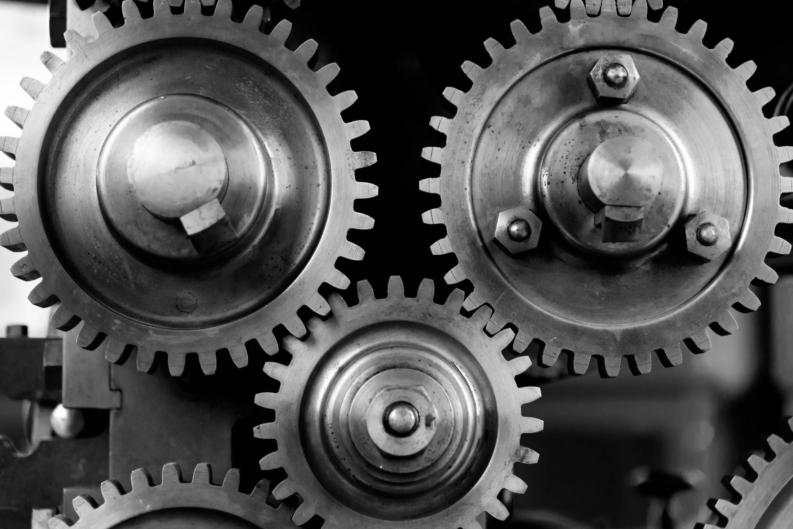High-contrast interlocking precision spur gears symbolizing TradeProofs multi-stage forensic evidence chain and mass-balance reconciliation